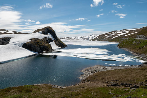 Mountain lake with melting snow on a Norwegian plateau