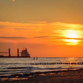 Sunset at the beach by Bert Zuidweg