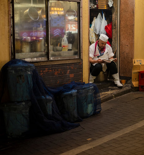 A man is taking a break from his restaurant in Tokyo