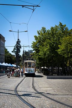 Tram next to a market in Porto, Portugal by Kelsey van den Bosch