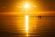 A summer sunset with two people in the water by Bas Meelker thumbnail
