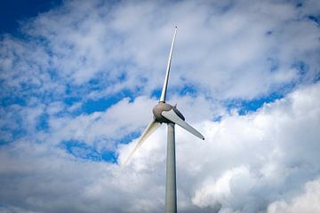 Wind turbine with a blue sky and clouds above by Sjoerd van der Wal