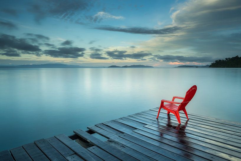 Red chair on the pier by Anges van der Logt