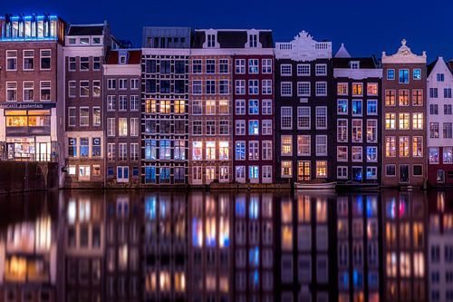 Canal houses on the Damrak in Amsterdam during the blue hour