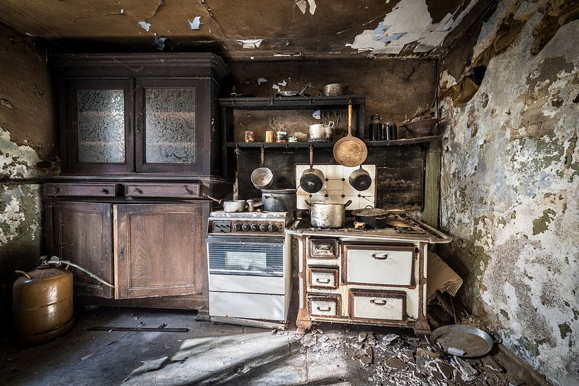 Old kitchen in abandoned and dilapidated house by Inge van den Brande