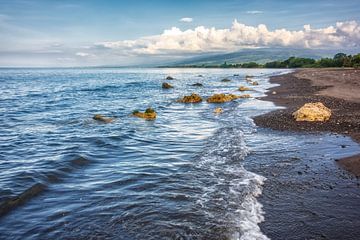 a dark sand beach in northern Bali Indonesia