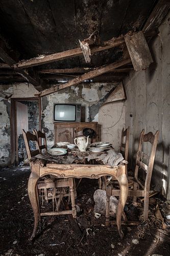Dining room with set table in dilapidated house by Inge van den Brande