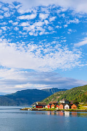 View across the Åkrafjord with wooden huts in Norway by Rico Ködder