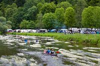 Canoeing on the river Semois with flowering water plants