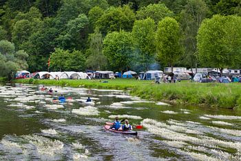 Canoeing on the river Semois with flowering water plants