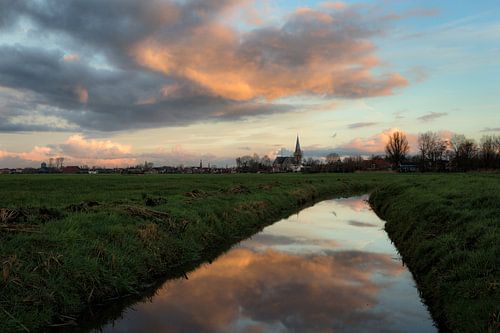 The town of IJlst in Friesland with a reflection of the sky in a ditch in the foreground One2expose 