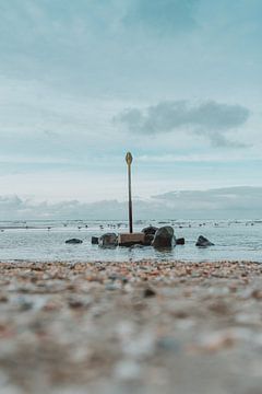 Beach marker and rocks by Jonai