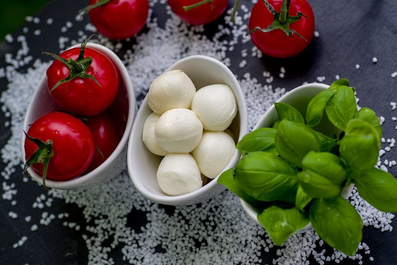 Tomatoes with fresh basil in bowls by Tanja Riedel