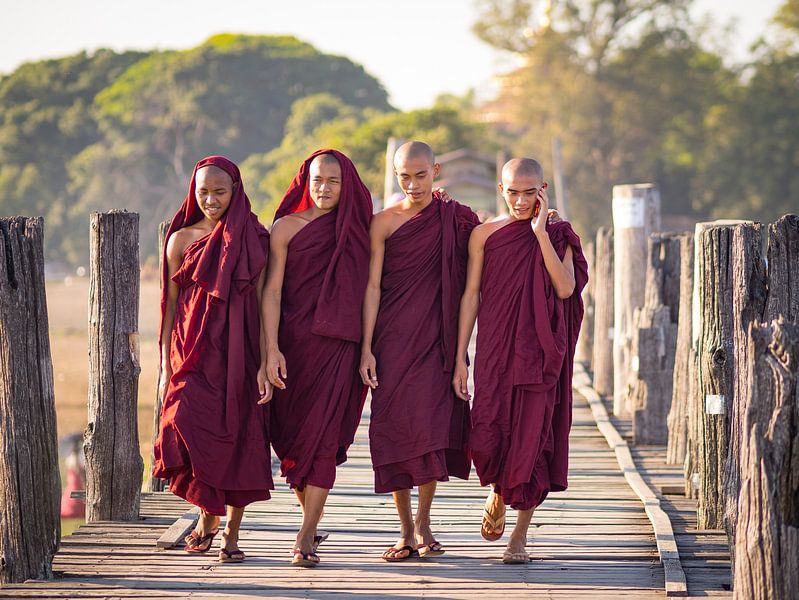 Buddhist monks on a bridge near Mandalay, Myanmar by Teun Janssen