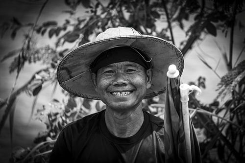 Smiling Thai man with rice hat in black and white