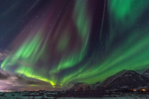 Breathtaking Aurora Borealis Above Snow-Capped Mountains