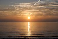 Sunset at the sea dyke at Huisduinen North Holland