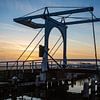 De ophaalbrug in de ruterpolder in IJlst Friesland bij zonsondergang. Wout Kok One2expose van Wout Kok