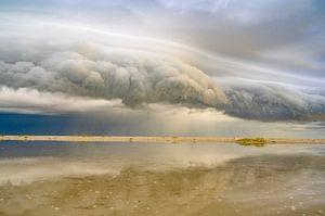 Sunrise at the beach at Texel island with a storm cloud approach