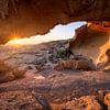 Sunrise under a stone arch by Ellen van den Doel
