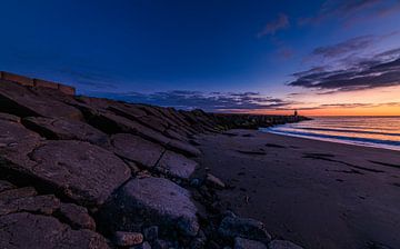 View towards the light beacon after sunset on the north pier by peterheinspictures