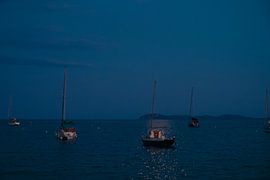 Sailboats at anchor on the beach by moonlight by Max van der Weide