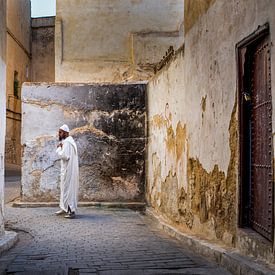 Moroccan man at the ancient walls of Fez by Paula Romein