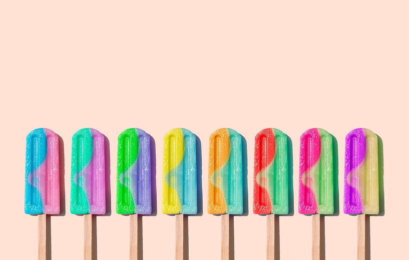 Row of rainbow-colored icecream lollies by Kaat Zoetekouw