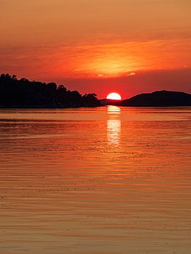 Sunset over archipelago islands in front of the town of Fjällbacka i by Rico Ködder