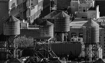 Water towers on the rooftops of New York City by Davey Bogaard
