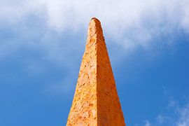 Orange stone in blue sky by Stella Ammerlaan