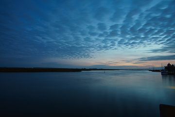 from the harbour in Zingst, the view of the Bodden with a burning sky by Martin Köbsch