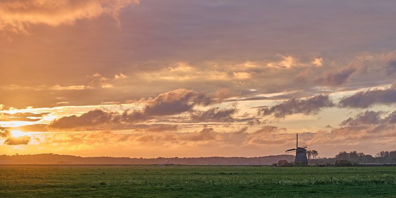 Mill in the polder of Egmond in a fiery sunset by Ronald Smits