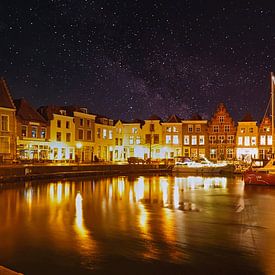 A clear starry sky over the beautifully lit harbour of Goes by Gert van Santen