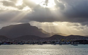 Sunbeams breaking through above the bay