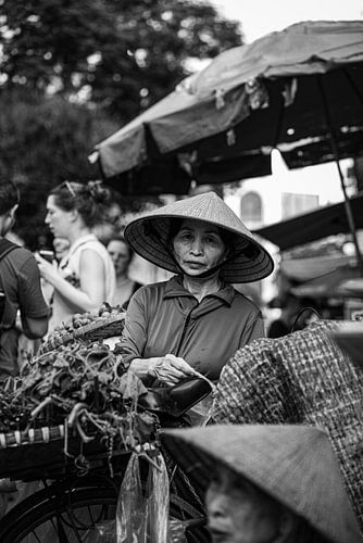 Woman sells herbs at market in Hanoi