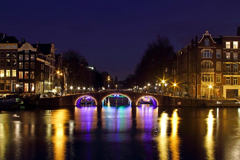 Illuminated bridge over the Amstel River in Amsterdam by Eye on You