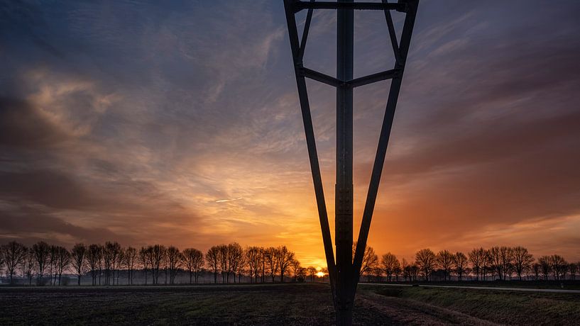 sunrise with high voltage pylon by Miranda Heemskerk