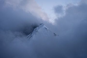 Mountain peak in the clouds by Michiel Dros