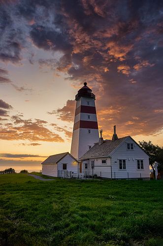 Colorful setting sun over Alnes lighthouse, Godøy, Norway