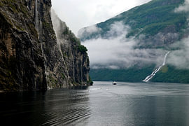 Ferry in the Geirangerfjord with a waterfall by Dlanor