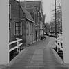 Chain bridge with old houses in Hoorn, North Holland by Paul Franke