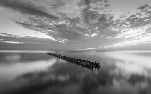 Brise-lames de l'IJsselmeer à Hindeloopen dans la province de Frise en noir et blanc sur Marga Vroom