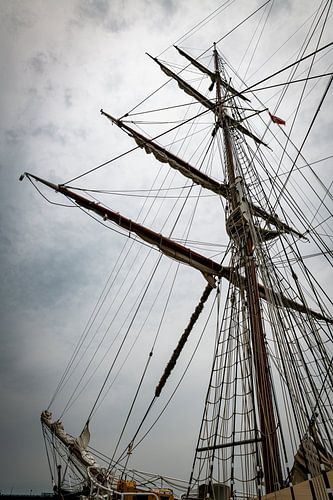 Majestic Tall Ship Masts Against a Cloudy Sky