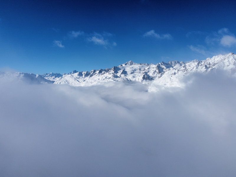 Central Swiss Alps above the clouds by Leo Schindzielorz