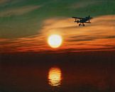 Flugzeug bei Sonnenuntergang über dem Meer von Jan Keteleer Miniaturansicht