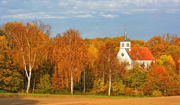 Village church surrounded by autumnal colours van Gisela Scheffbuch