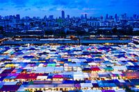 Evening market in Bangkok with hundreds of multi-coloured stalls.