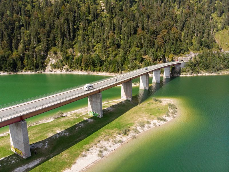 Aerial view of the Sylvenstein reservoir bridge with forest by Hans-Heinrich Runge