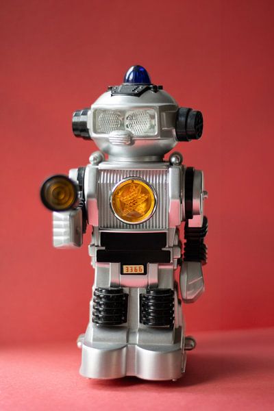 Vintage toy robot on red by Jolanda Grutter